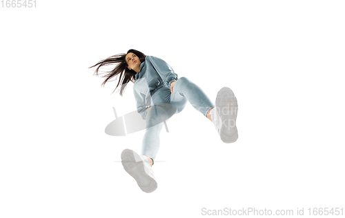 Image of Young stylish woman in modern street style outfit isolated on white background, shot from the bottom