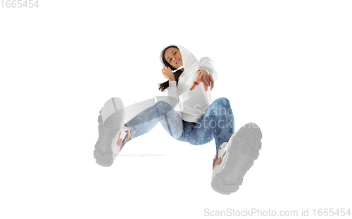 Image of Young stylish woman in modern street style outfit isolated on white background, shot from the bottom