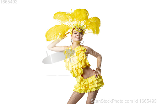 Image of Beautiful young woman in carnival, stylish masquerade costume with feathers dancing on white studio background.