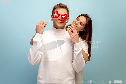 Image of Beautiful couple in love on blue studio background. Valentine\'s Day, love and emotions concept