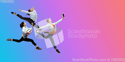 Image of Happy office workers jumping and dancing in casual clothes or suit on gradient neon fluid background. Flyer with copyspace