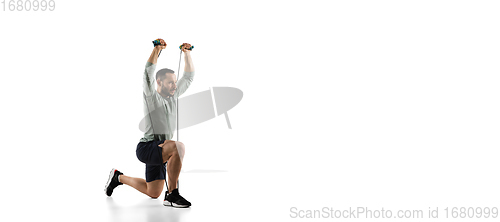 Image of Young caucasian male model in action, motion isolated on white background. Concept of sport, movement, energy and dynamic, healthy lifestyle. Training, practicing.