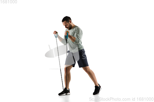 Image of Young caucasian male model in action, motion isolated on white background. Concept of sport, movement, energy and dynamic, healthy lifestyle. Training, practicing.