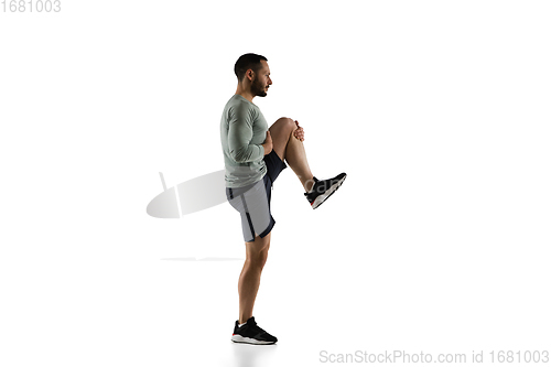 Image of Young caucasian male model in action, motion isolated on white background. Concept of sport, movement, energy and dynamic, healthy lifestyle. Training, practicing.