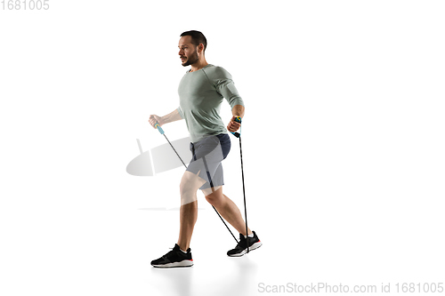 Image of Young caucasian male model in action, motion isolated on white background. Concept of sport, movement, energy and dynamic, healthy lifestyle. Training, practicing.