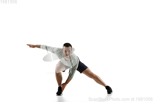 Image of Young caucasian male model in action, motion isolated on white background. Concept of sport, movement, energy and dynamic, healthy lifestyle. Training, practicing.