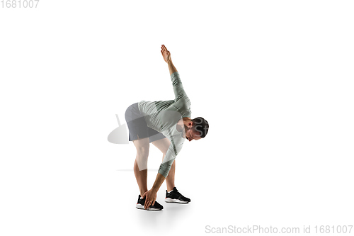Image of Young caucasian male model in action, motion isolated on white background. Concept of sport, movement, energy and dynamic, healthy lifestyle. Training, practicing.