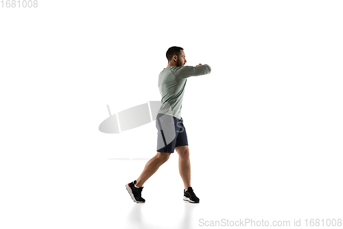 Image of Young caucasian male model in action, motion isolated on white background. Concept of sport, movement, energy and dynamic, healthy lifestyle. Training, practicing.