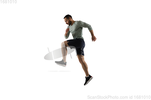 Image of Young caucasian male model in action, motion isolated on white background. Concept of sport, movement, energy and dynamic, healthy lifestyle. Training, practicing.