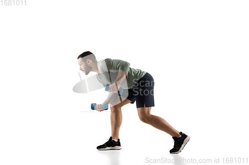 Image of Young caucasian male model in action, motion isolated on white background. Concept of sport, movement, energy and dynamic, healthy lifestyle. Training, practicing.