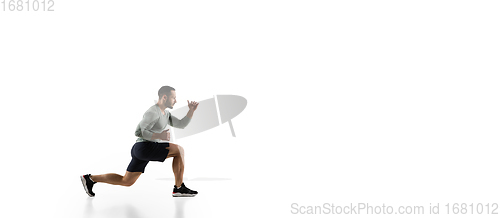 Image of Young caucasian male model in action, motion isolated on white background. Concept of sport, movement, energy and dynamic, healthy lifestyle. Training, practicing.