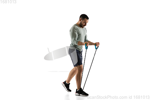 Image of Young caucasian male model in action, motion isolated on white background. Concept of sport, movement, energy and dynamic, healthy lifestyle. Training, practicing.