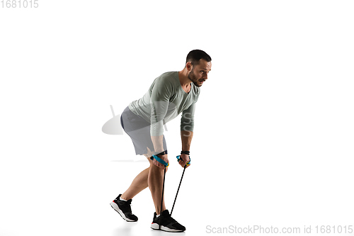 Image of Young caucasian male model in action, motion isolated on white background. Concept of sport, movement, energy and dynamic, healthy lifestyle. Training, practicing.