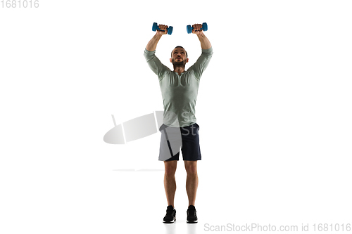 Image of Young caucasian male model in action, motion isolated on white background. Concept of sport, movement, energy and dynamic, healthy lifestyle. Training, practicing.