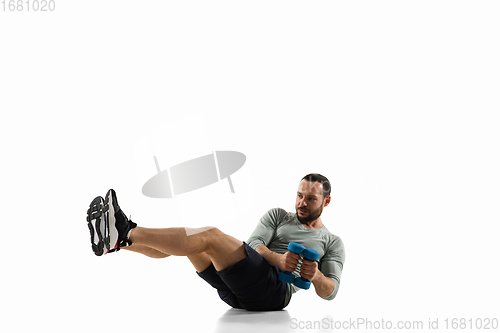 Image of Young caucasian male model in action, motion isolated on white background. Concept of sport, movement, energy and dynamic, healthy lifestyle. Training, practicing.