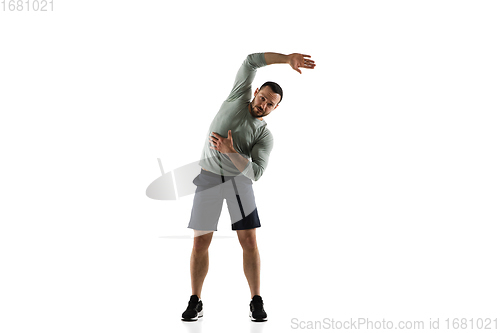 Image of Young caucasian male model in action, motion isolated on white background. Concept of sport, movement, energy and dynamic, healthy lifestyle. Training, practicing.