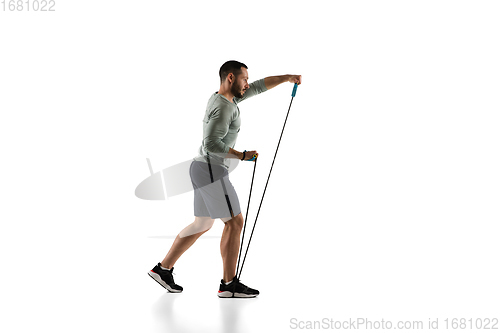 Image of Young caucasian male model in action, motion isolated on white background. Concept of sport, movement, energy and dynamic, healthy lifestyle. Training, practicing.