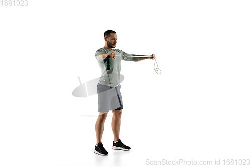 Image of Young caucasian male model in action, motion isolated on white background. Concept of sport, movement, energy and dynamic, healthy lifestyle. Training, practicing.