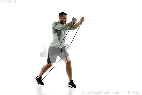 Image of Young caucasian male model in action, motion isolated on white background. Concept of sport, movement, energy and dynamic, healthy lifestyle. Training, practicing.