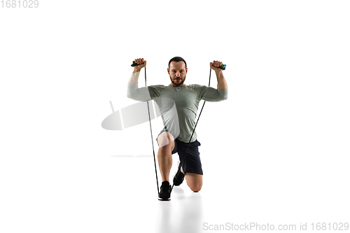 Image of Young caucasian male model in action, motion isolated on white background. Concept of sport, movement, energy and dynamic, healthy lifestyle. Training, practicing.