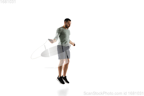 Image of Young caucasian male model in action, motion isolated on white background. Concept of sport, movement, energy and dynamic, healthy lifestyle. Training, practicing.