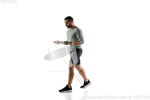 Image of Young caucasian male model in action, motion isolated on white background. Concept of sport, movement, energy and dynamic, healthy lifestyle. Training, practicing.