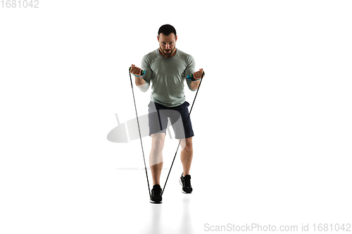 Image of Young caucasian male model in action, motion isolated on white background. Concept of sport, movement, energy and dynamic, healthy lifestyle. Training, practicing.