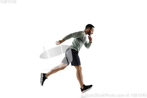 Image of Young caucasian male model in action, motion isolated on white background. Concept of sport, movement, energy and dynamic, healthy lifestyle. Training, practicing.