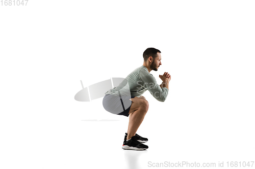 Image of Young caucasian male model in action, motion isolated on white background. Concept of sport, movement, energy and dynamic, healthy lifestyle. Training, practicing.