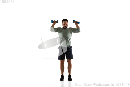 Image of Young caucasian male model in action, motion isolated on white background. Concept of sport, movement, energy and dynamic, healthy lifestyle. Training, practicing.