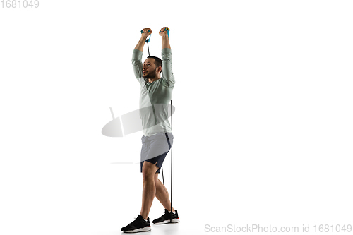 Image of Young caucasian male model in action, motion isolated on white background. Concept of sport, movement, energy and dynamic, healthy lifestyle. Training, practicing.