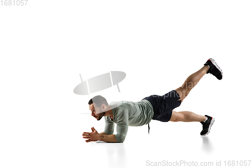 Image of Young caucasian male model in action, motion isolated on white background. Concept of sport, movement, energy and dynamic, healthy lifestyle. Training, practicing.