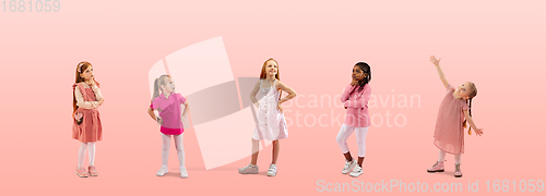 Image of Group of elementary school kids or pupils dreaming in colorful casual clothes on pink studio background. Creative collage.