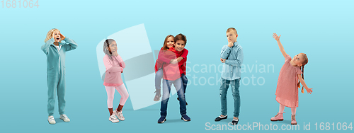 Image of Group of elementary school kids or pupils dreaming in colorful casual clothes on blue studio background. Creative collage.