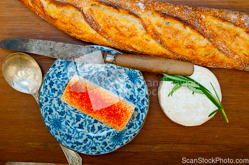 Image of French cheese and fresh  baguette on a wood cutter