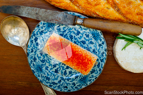 Image of French cheese and fresh  baguette on a wood cutter