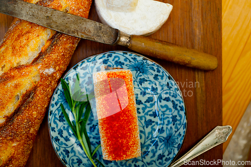 Image of French cheese and fresh  baguette on a wood cutter