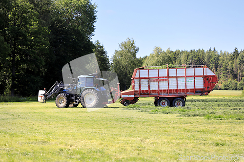 Image of Tractor and Forage Trailer Collecting Hay for Silage