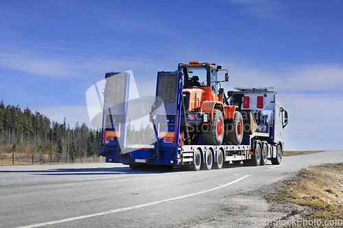 Image of White Semi Truck Transports Wheel Loader
