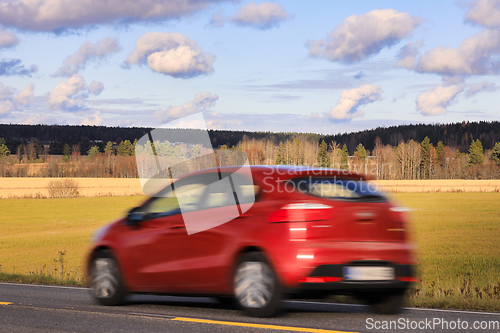 Image of Red Car at Speed on Highway