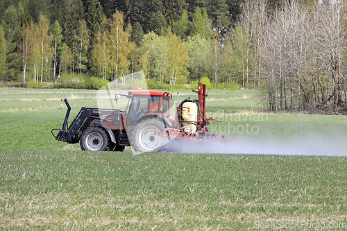 Image of Tractor and Sprayer in Field in the Spring