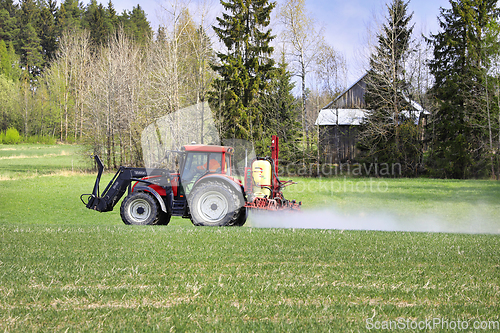 Image of Tractor and Sprayer in Field in the Spring