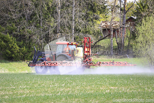 Image of Tractor and Sprayer in Field in the Spring