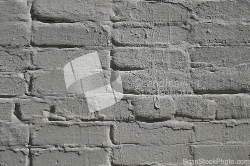 Image of Detail of old brick exterior many times painted wall, gray color