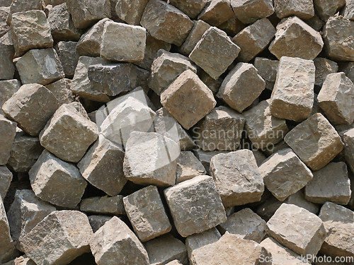 Image of Pile of gray street paving mostly cubic shape before stealing th