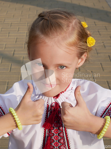 Image of Caucasian blonde little girl in festive Ukrainian embroidered sh