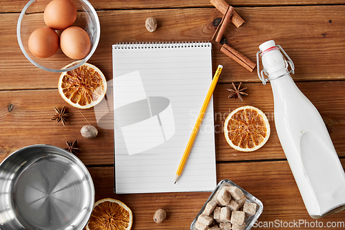 Image of notebook, pencil, ingredients for eggnog cooking