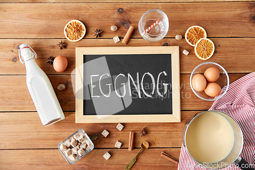 Image of eggnog word on chalkboard, ingredients and spices