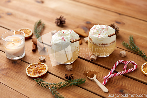 Image of glasses of eggnog with whipped cream and spices