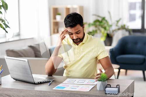 Image of ui designer working on user interface at home